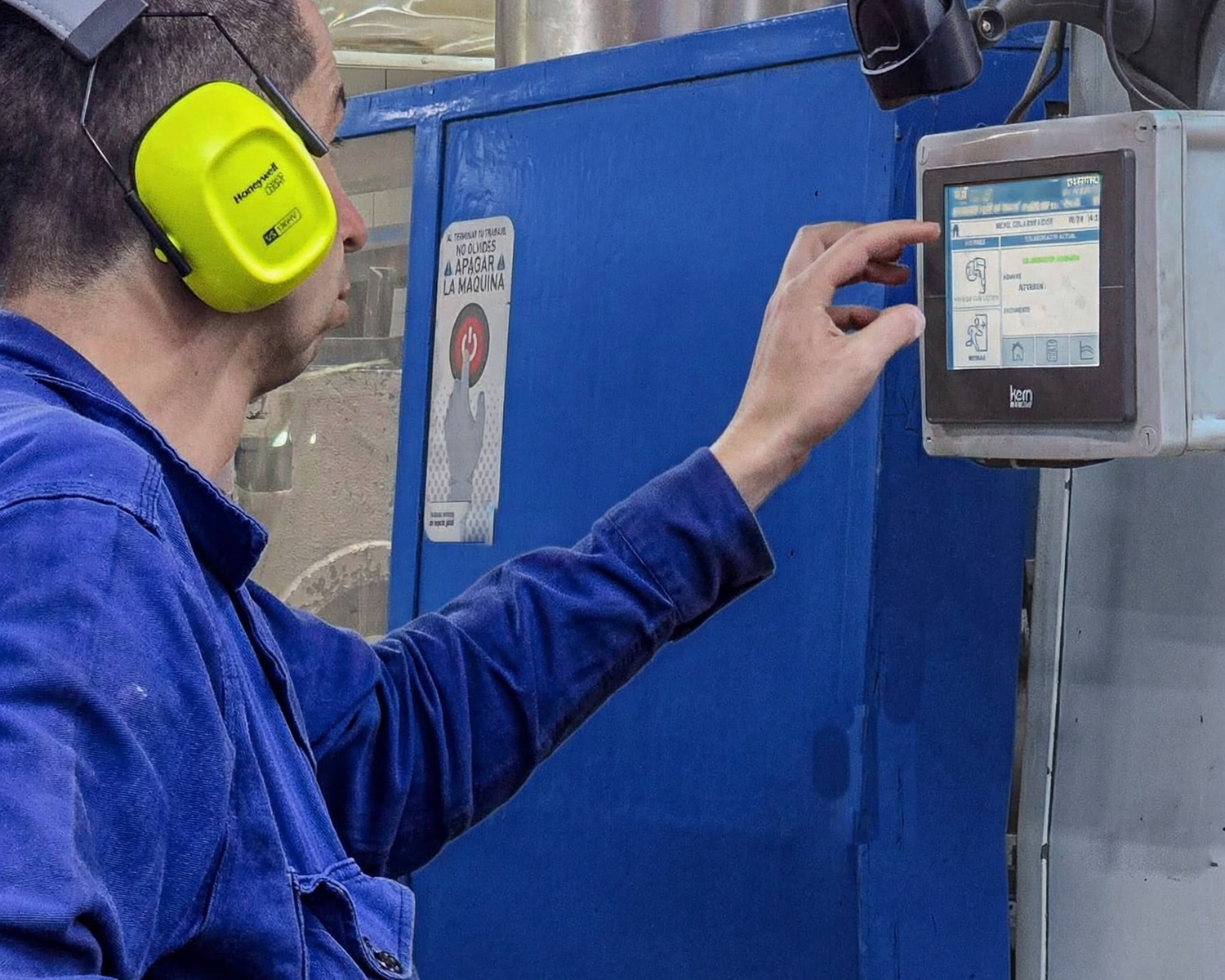 Técnico de planta operando un KERN IoP SMARTPRO instalado en una máquina de producción.